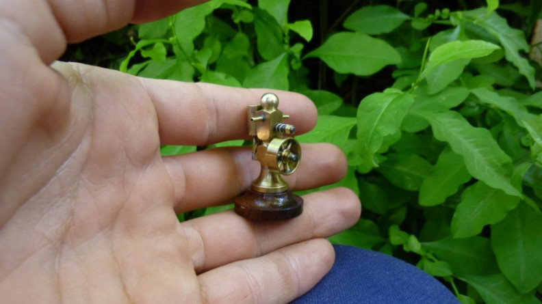 Micro engine held in hand to show size
